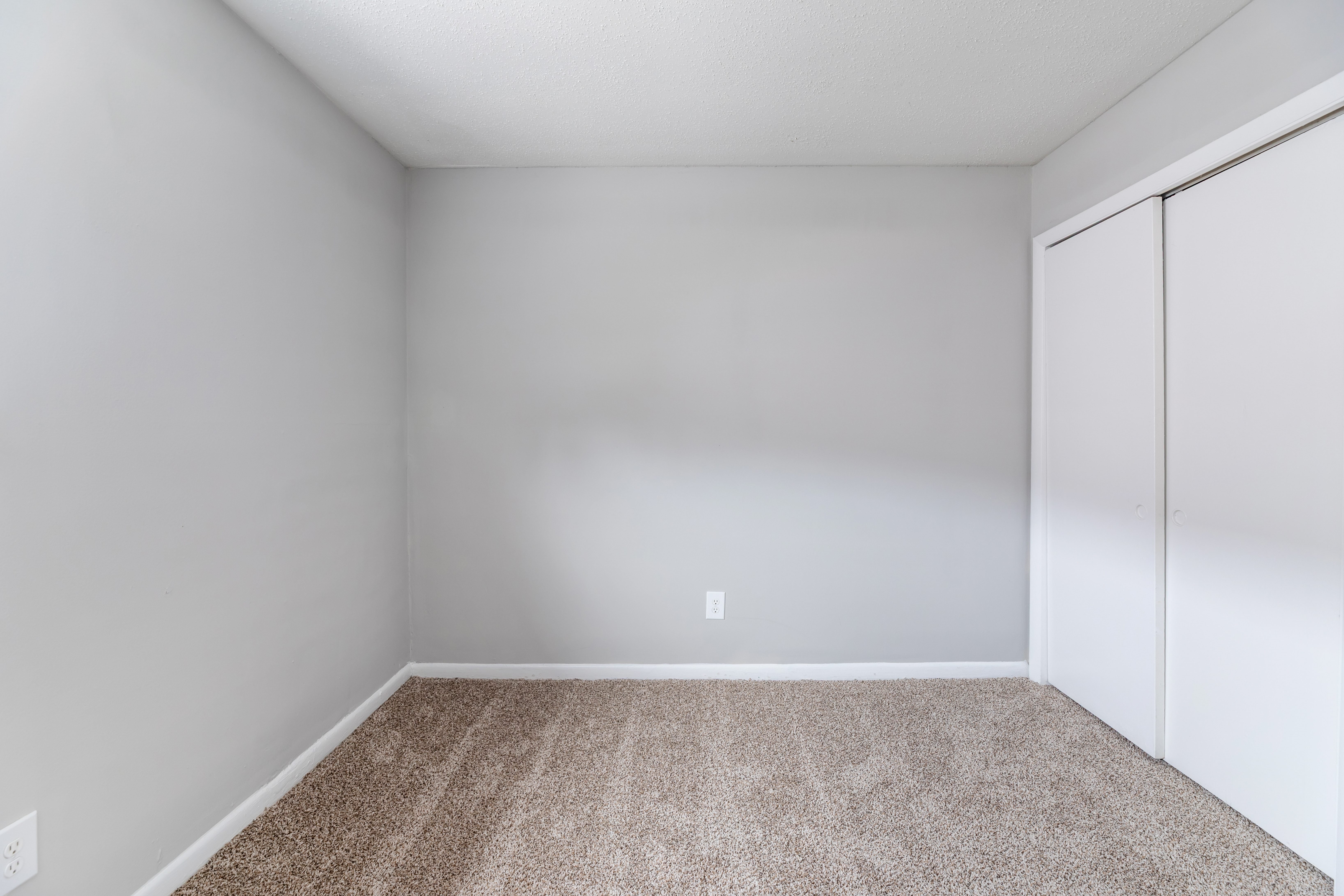 A room with a carpeted floor and a white wall.at Lauradale, Jacksonville